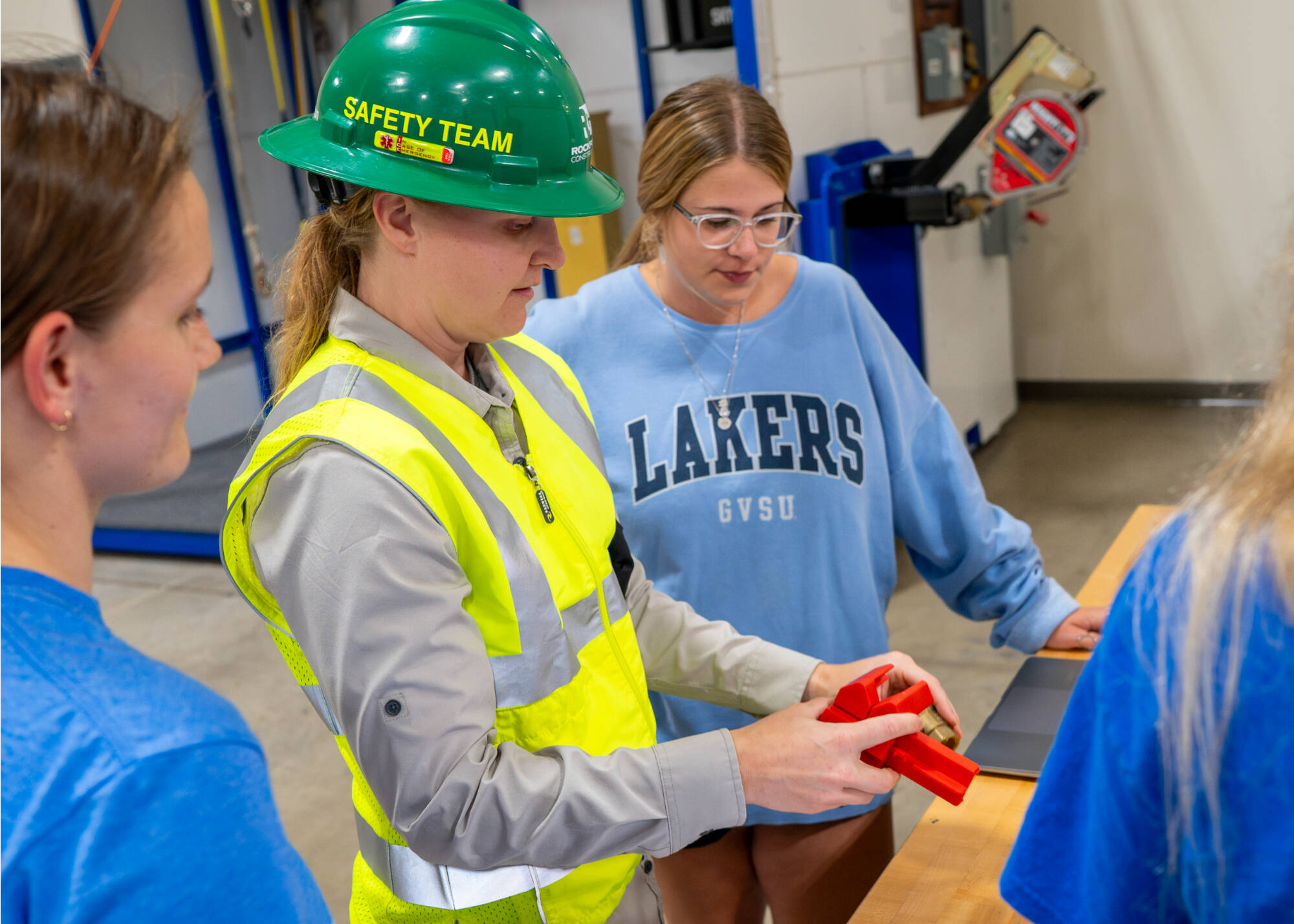 Rockford Construction’s Marissa Alverson, second from left, talks with GVSU Occupational Safety and Health students Alexis Schliewe, left, and Lindsey Pelton at the Innovation Design Center in downtown Grand Rapids. (Photo releases on file)